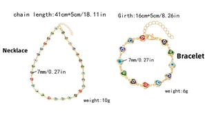 Detail view of Evil Eye heart charm jewelry set with 7mm beads on gold plated chain