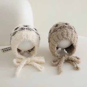 Close-up of soft plush jacquard baby earflap hats with adjustable knit straps