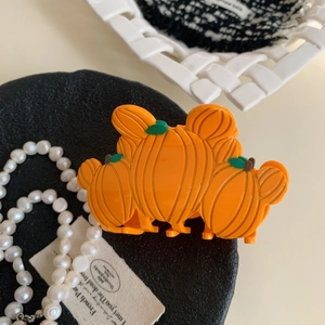 Pinza per capelli arancione in acetato a forma di zucca con dettaglio foglia verde