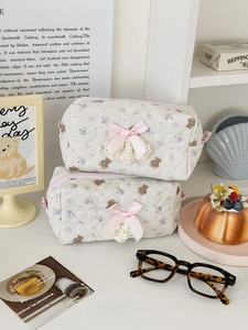 Cute quilted bear storage bag with lace and pink bow in a minimalist lifestyle setting