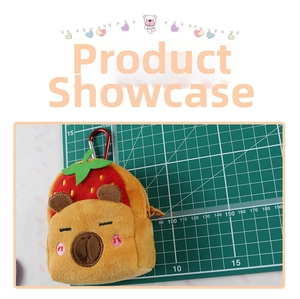 Close-up of plush Capybara coin purse with strawberry hat and red metal carabiner clip