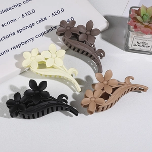 Matte floral hair claws in black, beige, and brown shades with double flower design