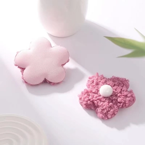 Close-up of pink teddy velvet floral spring accessories with soft plush texture and white core