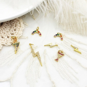 Macro shot of 18K gold plated charms with rainbow and lightning micro-pave crystals