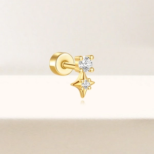 Detailed view of a gold s925 silver stud earring with round and star-shaped zircons