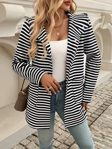 Dettaglio di un cardigan da donna a righe bianche e nere con cappuccio e bottone