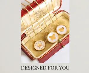 Detailed macro view of gold-plated necklaces with shell star, butterfly, and heart pendants