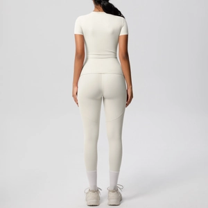 Close-up back view of beige two-piece yoga set showing high-waist leggings and slim-fit top