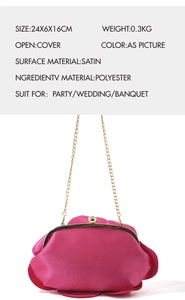 Detail of rose-shaped satin clutch bag in fuchsia with golden chain strap and clasp