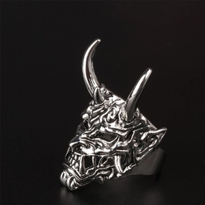 Macro shot of silver bull devil mask ring featuring intricate textures and sharp horns