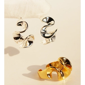 Abstract geometric wave earrings and rings set in polished gold and silver finishes