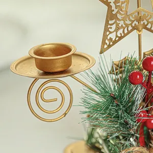 Golden metal Christmas candle holder with hollow star, pine needles and red berries
