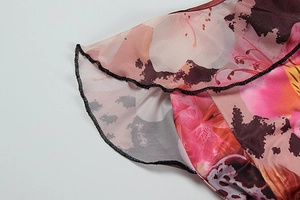 Macro shot of abstract floral mesh fabric with black ruffled edge and delicate stitching