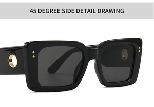 Close-up of black square sunglasses featuring a decorative golden hollow circular detail