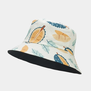 Detail of reversible bucket hat featuring cartoon durian print and solid black inner side