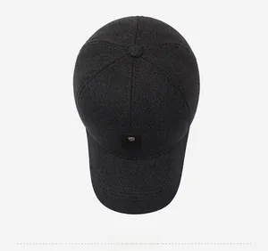 Top view detail of dark grey thick twill winter cap for men showing metal logo