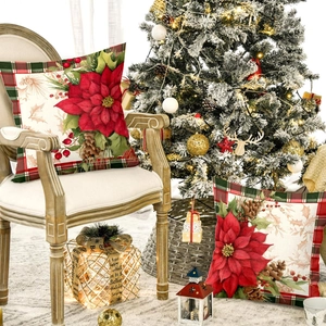 Christmas poinsettia pillow covers with plaid border on a festive holiday chair