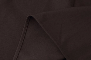 Macro view of dark brown midi dress fabric showing fine twill texture and neat stitching