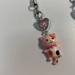 Close-up of a pink resin cartoon cat keychain with a heart-shaped metal ring detail
