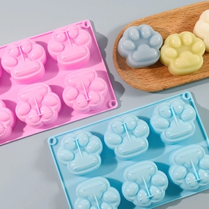 Detailed view of 6-cavity cat paw silicone mold with colorful resin and soap crafts