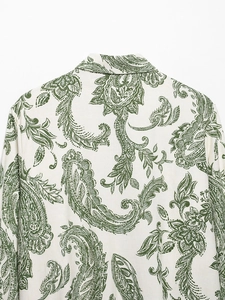 Close-up of green Paisley print on ivory shirt back featuring fine cotton-linen texture