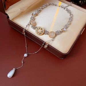 Macro detail of vintage teardrop pearl pendant necklace with diamond accents in a gift box