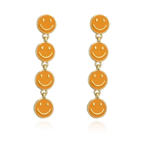 Detail of orange enamel smiley face long drop earrings with gold metal frame