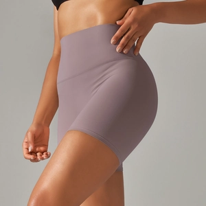 Detailed side view of high-waist purple yoga shorts with seamless elastic fabric