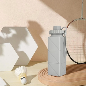 Close-up of gray collapsible silicone sports bottle with geometric texture and handle