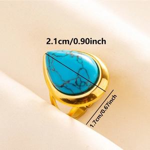 Macro detail of adjustable gold ring featuring a large teardrop turquoise stone
