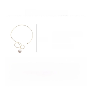 Detail view of gold choker necklace with twisted iron wire and large imitation pearl charm