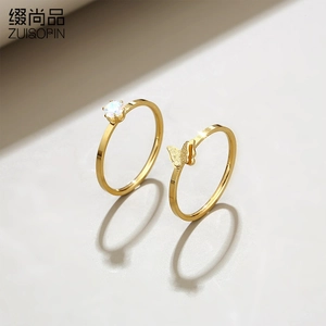 Detailed view of two-piece gold titanium steel ring set with butterfly and crystal