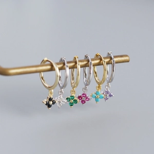 Close-up of S925 sterling silver four-leaf clover earrings in multiple vibrant colors