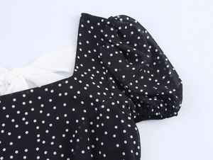 Detail of square neckline and back bow on a French-style polka dot dress