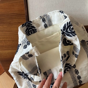 Détails intérieurs du sac en lin brodé montrant le fermoir magnétique et la poche interne