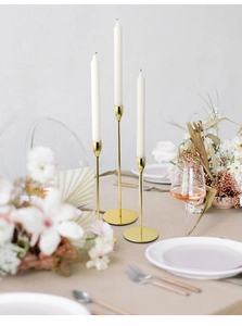 Elegant gold metal candlesticks in three heights for romantic wedding table decoration