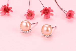 Detailed macro view of pink freshwater pearl earrings with diamond accents on S925 silver