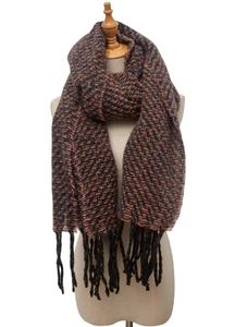 Detailed close-up of multicolor herringbone knit scarf with long black tassels on a mannequin