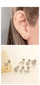 Macro detail of G23 titanium heart and balloon dog stud earrings with gold plating