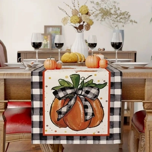 Close-up of harvest pumpkin table runner with black and white gingham checkered bow