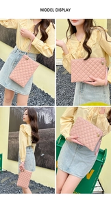 Pink quilted faux leather clutch bag featuring a gold zipper and wrist strap detail