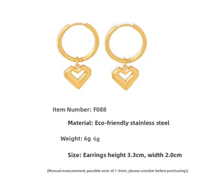 Detailed view of gold stainless steel heart earrings with 3.3cm height and 2cm width