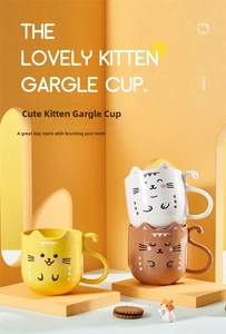 Detailed view of three cute cat-shaped tooth mugs in yellow, white, and brown colors