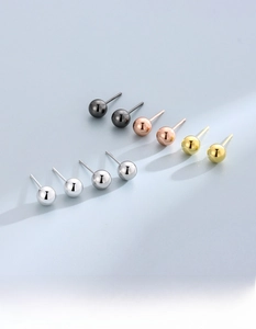 Macro shot of S925 sterling silver ball studs in black, rose gold, gold and silver