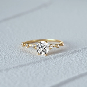 Macro shot of a luxury gold ring with a large round brilliant cut centerpiece diamond