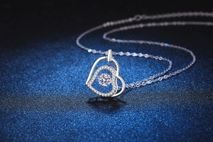 Macro detail of S925 sterling silver heart pendant with dancing Moissanite stone