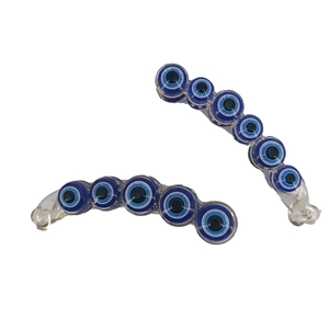 Set of two transparent banana hair clips with blue evil eye beads on white background