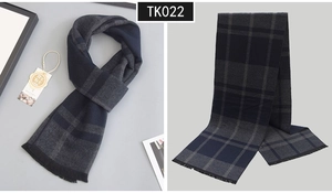 Detailed view of navy and dark grey plaid wool scarf with soft fringe edges