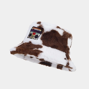 Brown cow print fuzzy bucket hat with vintage boombox patch for winter warmth