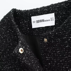 Chic black tweed jacket with gold buttons and premium woven texture from a front view